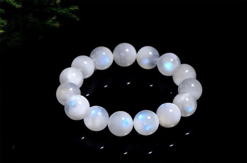Natural blue moonlight polished moonstone round bead bracelet on wrist.