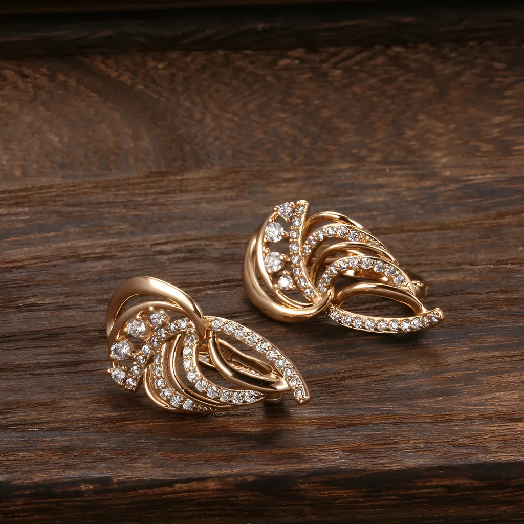 Gold-plated copper ear clips with geometric wing design and micro-inlaid zircon gemstones