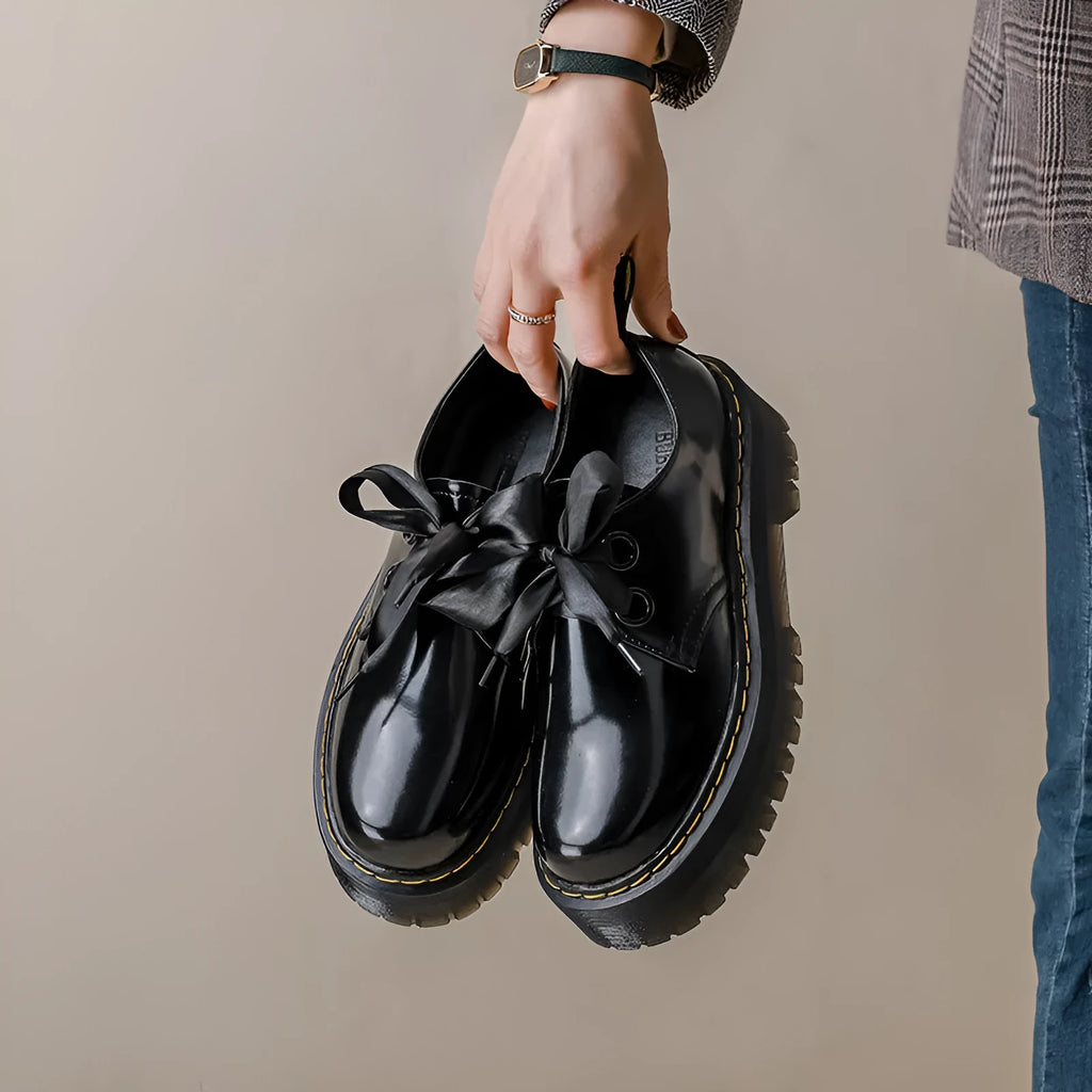 Women's thick-soled leather shoes with decorative ribbon cross-straps in black colour option