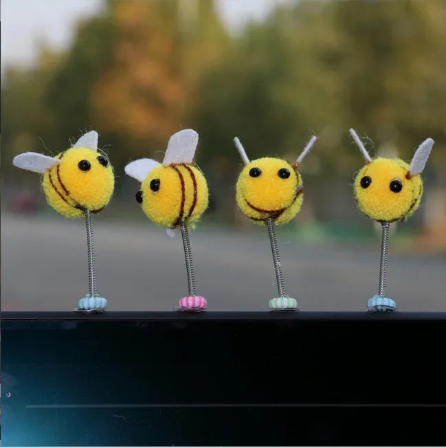Swing Spring Bee soft fur ball car decoration with cartoon bee shape on adhesive backing.