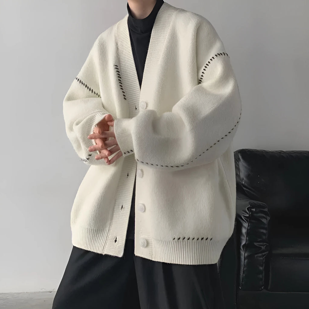 Women's loose-fit knitted cardigan top coat in black or white.
