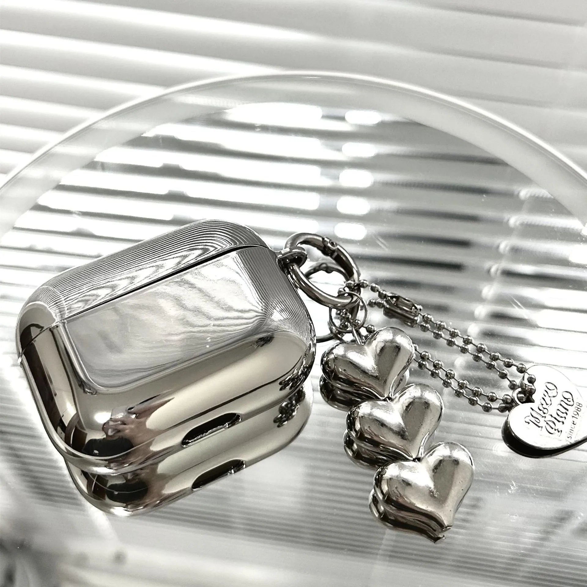 Electroplated solid colour TPU AirPods case with heart pendant charm and chain attachment