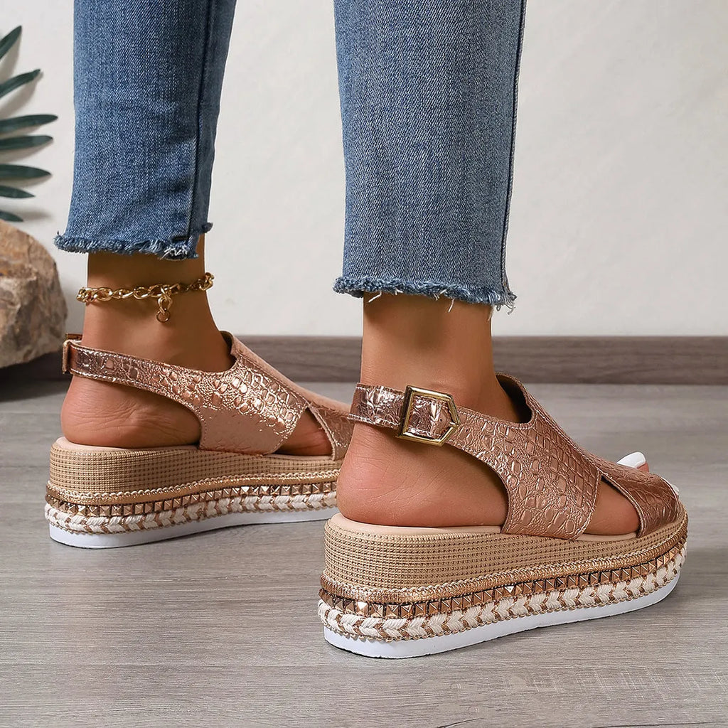 Gold women's Roman sandals with round toe, hollow-out upper, and an ankle buckle.