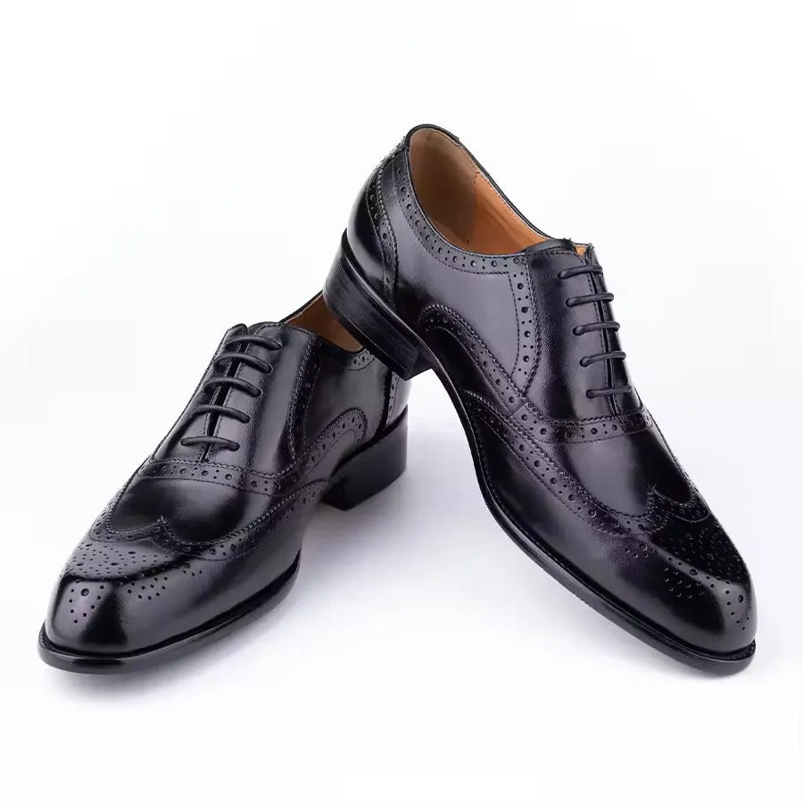 Men's purple leather oxford shoes with hand-carved detailing and a pointed toe on a rubber sole.