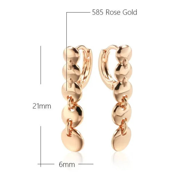 Gold retro long woven copper circle hoop earrings on a white background
