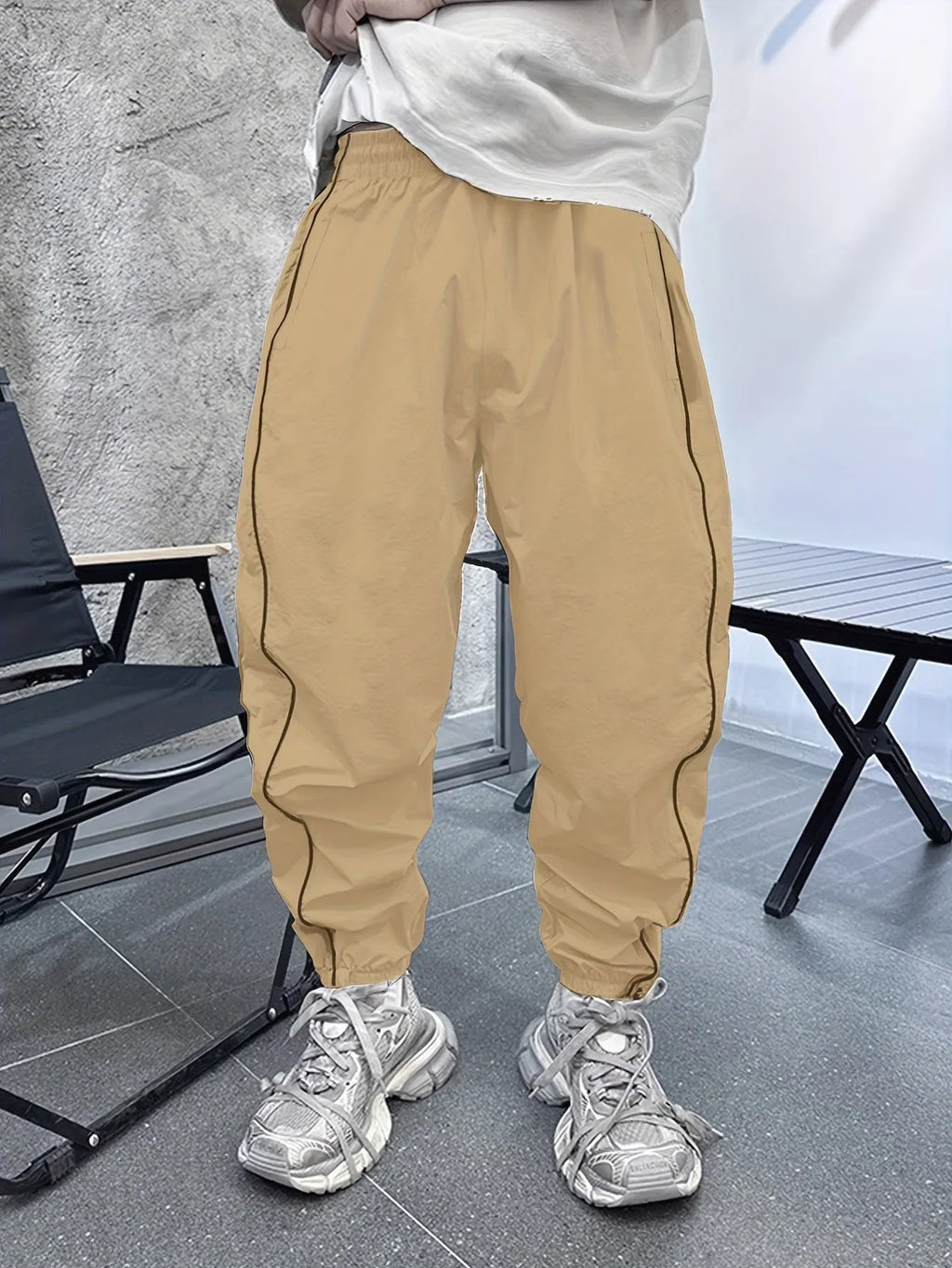 Man wearing loose, cropped blue bamboo fibre casual trousers.