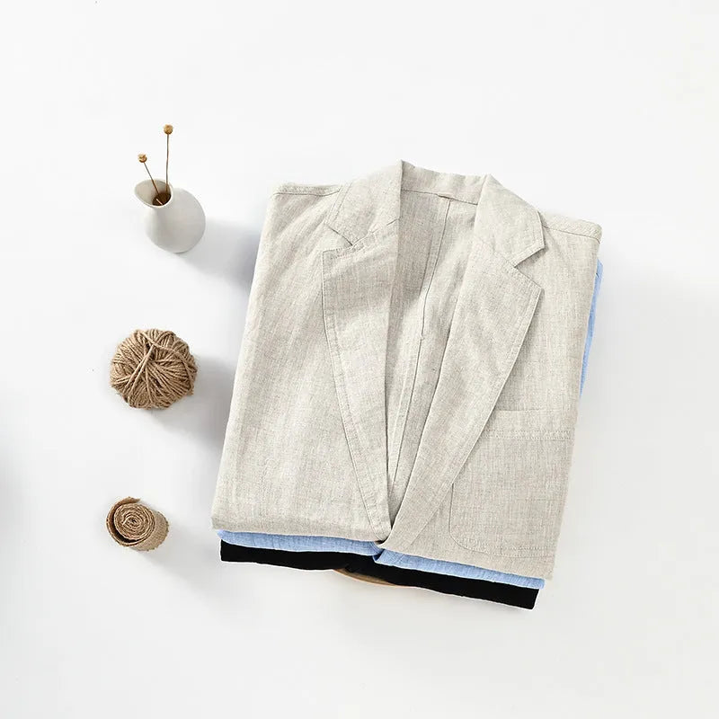 Men's solid colour linen suit blazer with side stick pockets, shown in light blue.
