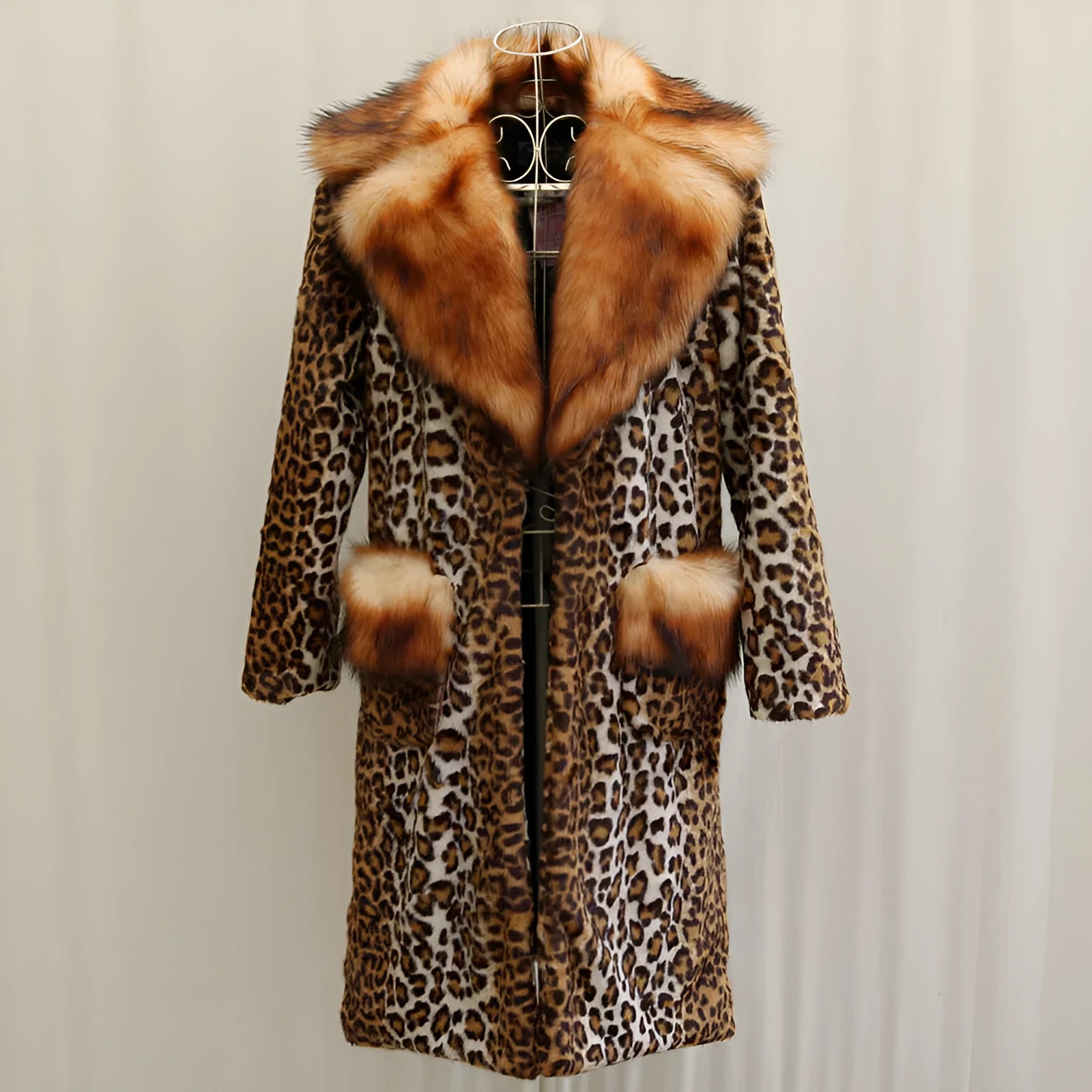 Women's long faux fur leopard print jacket with regular sleeves on a hanger.