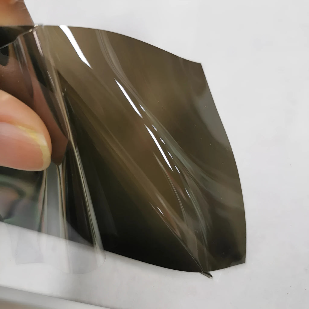 A roll of 30 cm wide TPU car lamp protective film for large LED lampshades, shown in a dark gray finish.