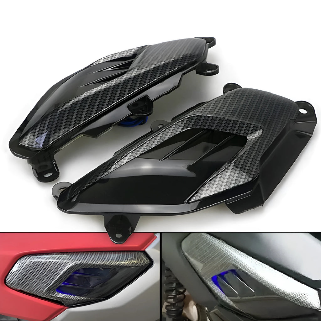 Pair of Yamaha NMAX side lamps with LED light and carbon fibre decoration on a black background.