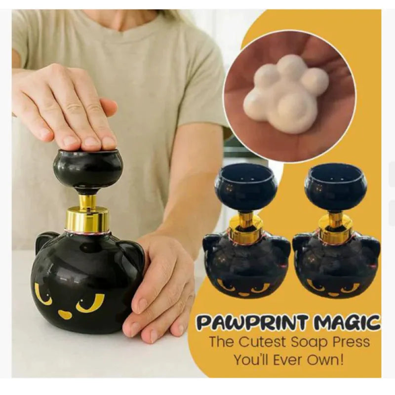 Black cartoon cat shaped plastic foam soap dispenser on a counter.