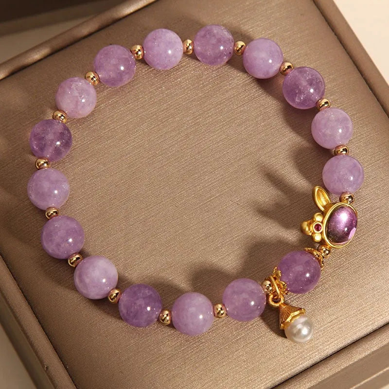 Purplish red mauve jade rabbit head charm on a clear crystal bracelet, Mori style design.