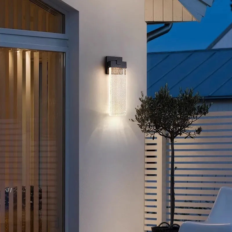 Black stainless steel outdoor LED wall lamp for courtyard or corridor mounting.