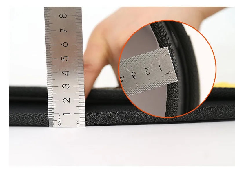 Black nylon fitness weightlifting waistband with adjustable hook and loop closure laid flat.