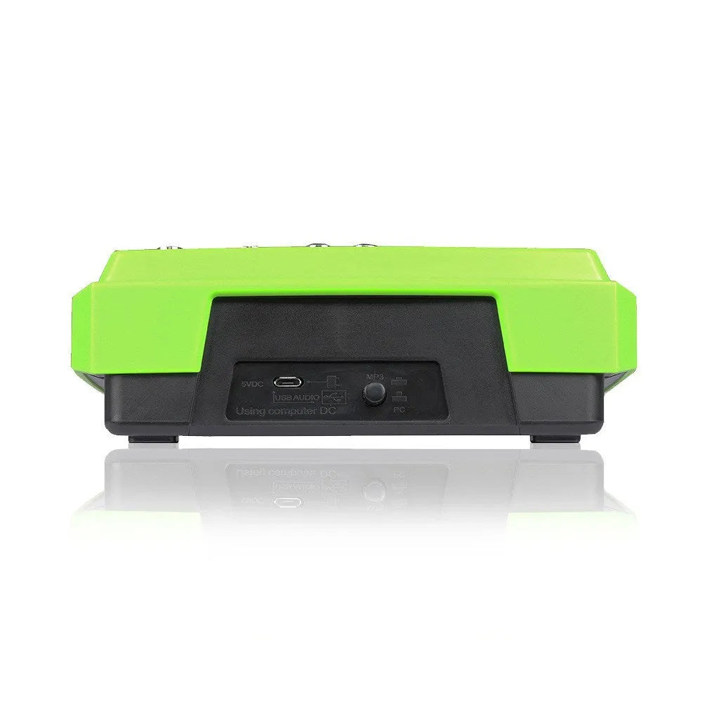 Green USB reverb audio processor and mixer unit with power adapter and cables on a desk.