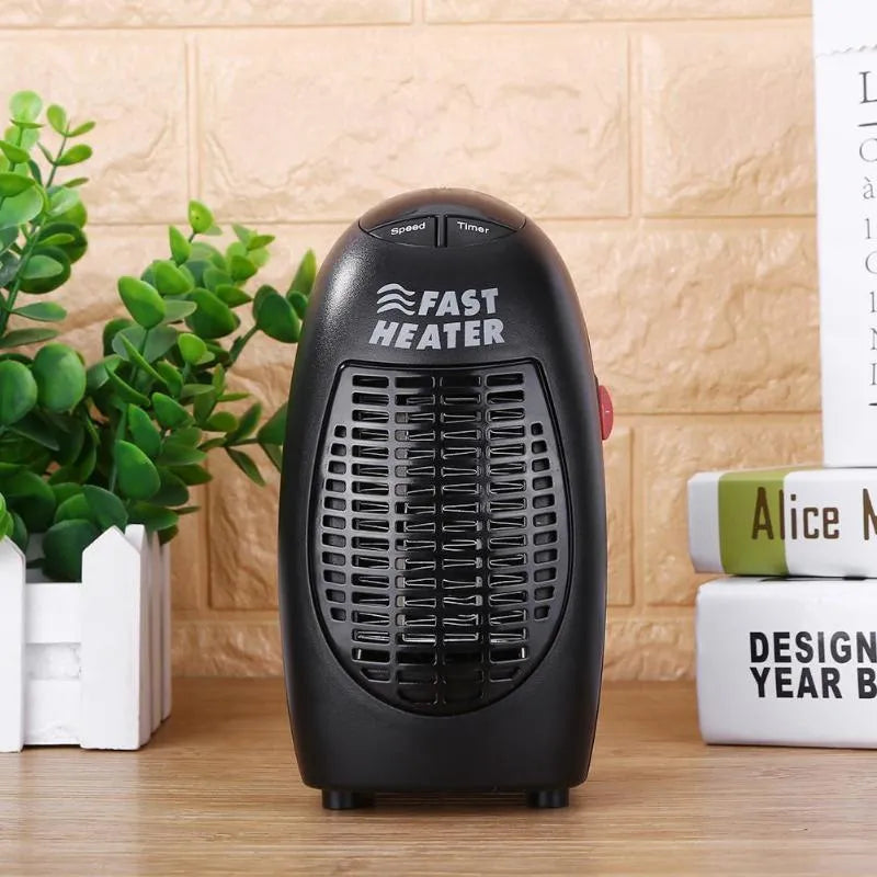 Black mini electric heater with digital display and a rotating plug on a table.