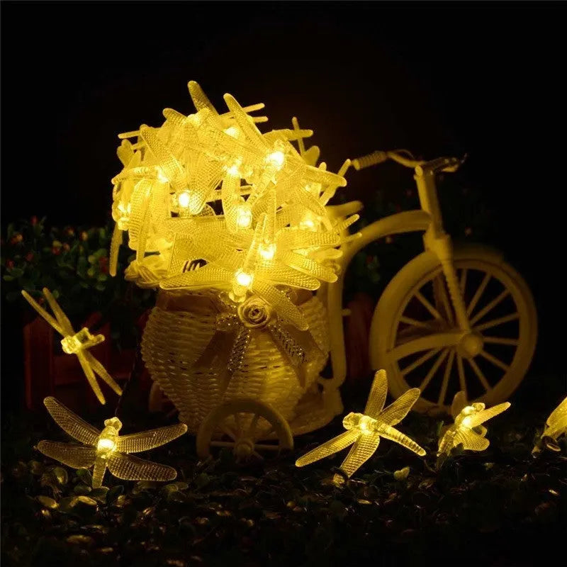 5 metre long solar-powered LED string lights with 30 warm white bulbs, shown with a solar panel on a spike for garden decoration.