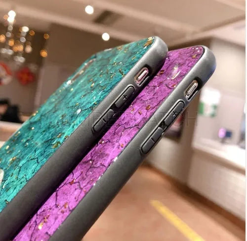 Silicone phone case with gold foil epoxy decoration in a purple solid colour, shown fitted on a smartphone.