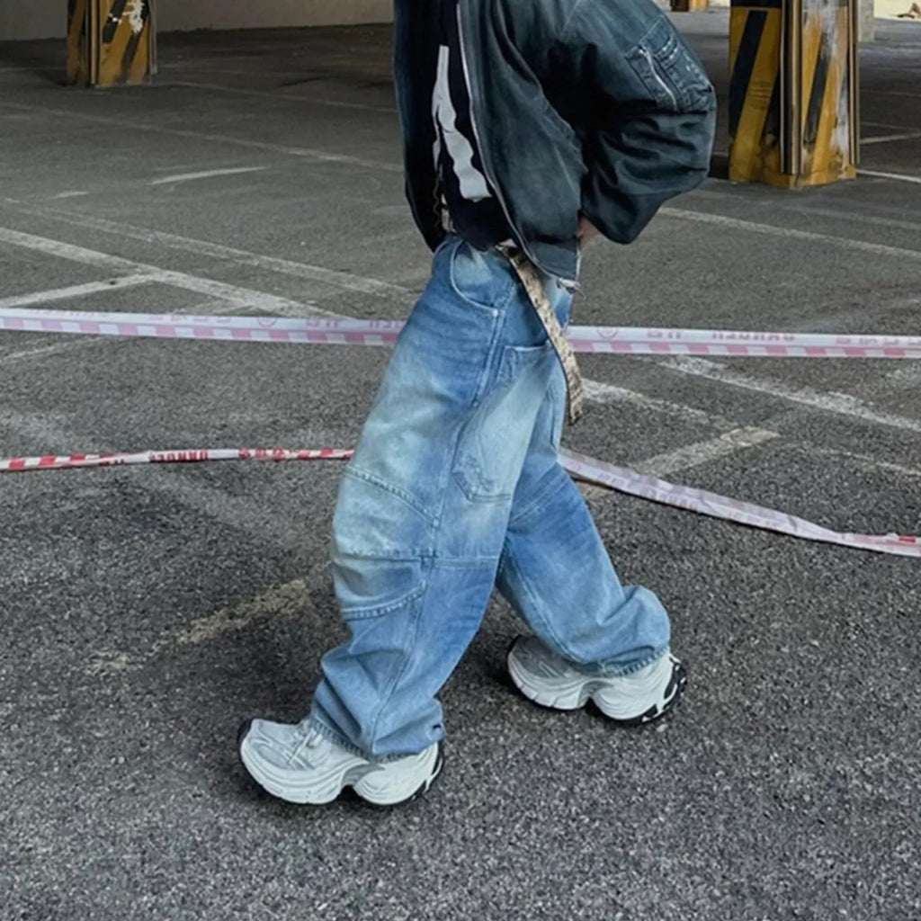 Men's light blue baggy jeans with front pleats and a straight-leg fit on a plain background.