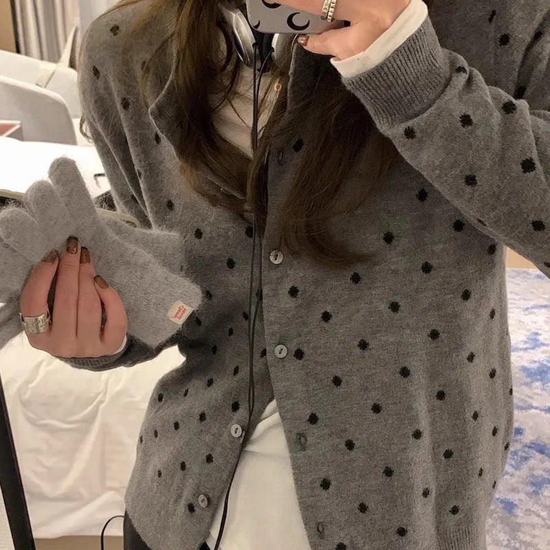Women's grey and black Korean-style loose knit cardigan with crochet flower detail on the front.