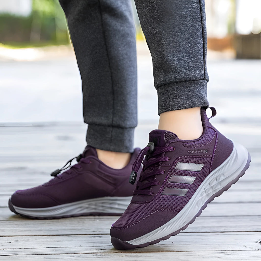 Men's and women's casual slip-on shoes with mesh upper and elastic band closure in black, purple, dark grey, and purplish red.