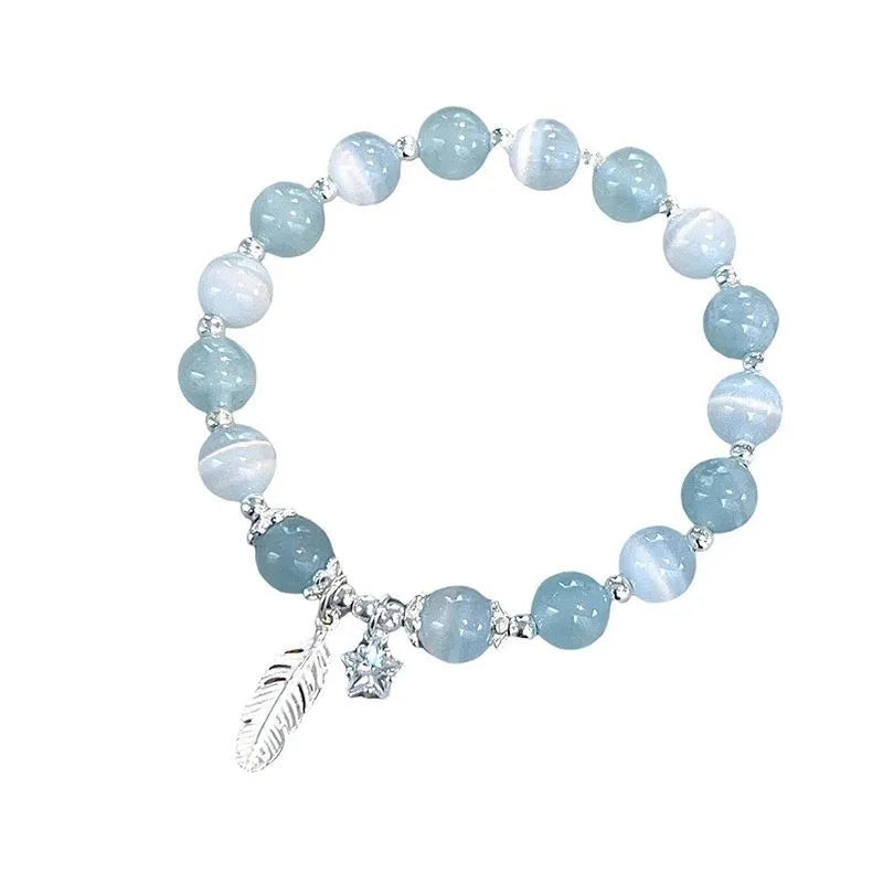 Glass crystal bracelet with coloured glaze in blue moonlight colour showing text modelling and eight-point star detail