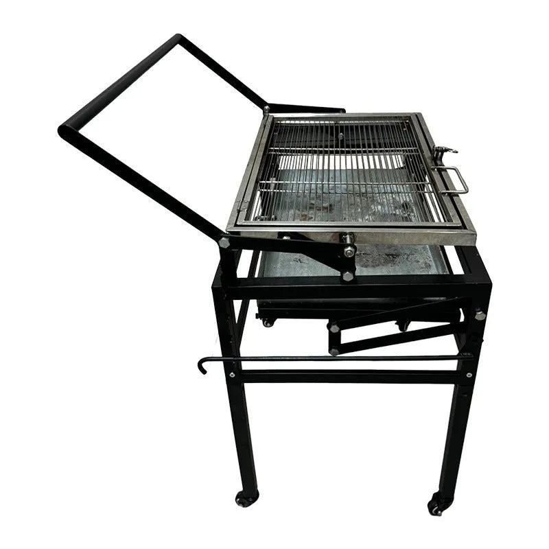 Large portable charcoal barbecue grill with a foldable metal frame set up in a garden.