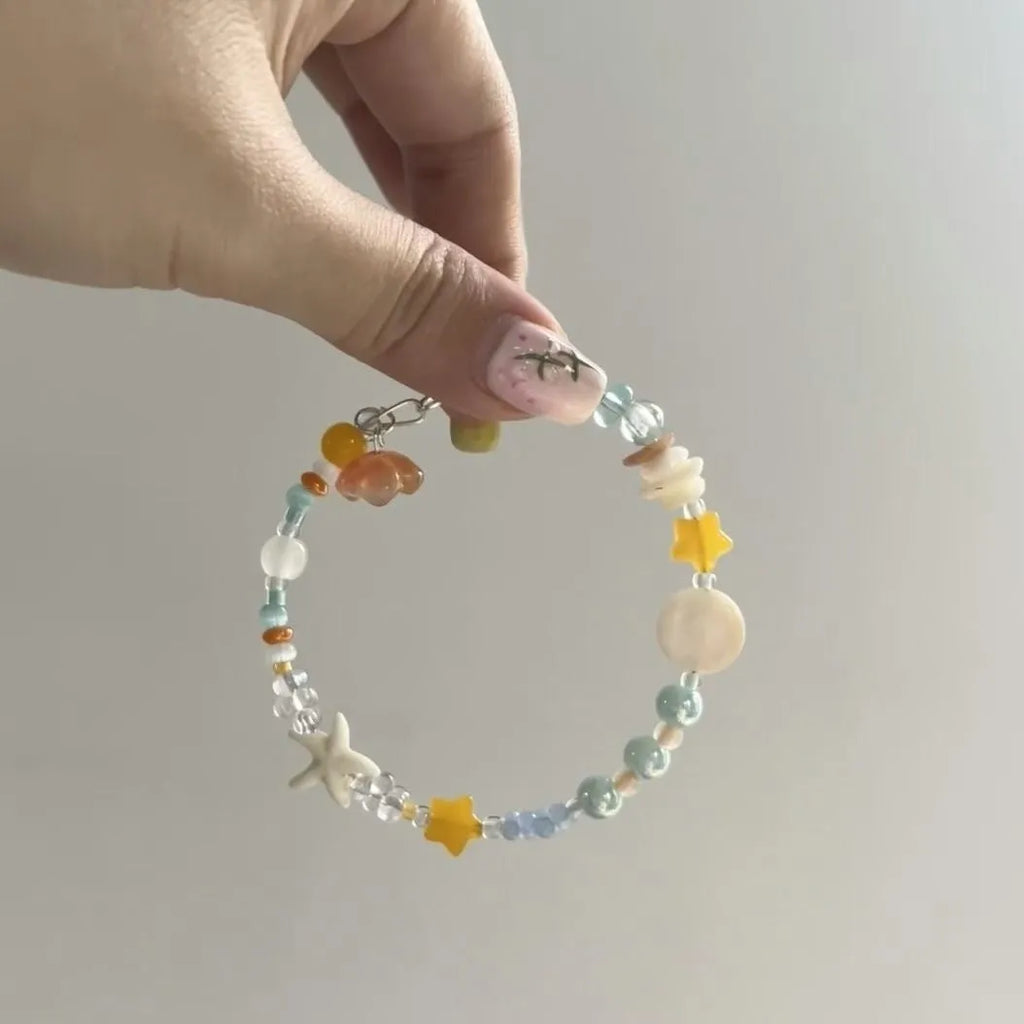 Orange water-soaked alloy bracelet with diamond shape and round elements for summer seaside styling