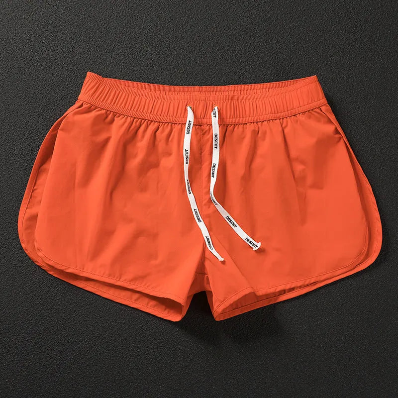 Men's loose-fitting beach shorts in orange, fluorescent green, and black colours on a size chart background
