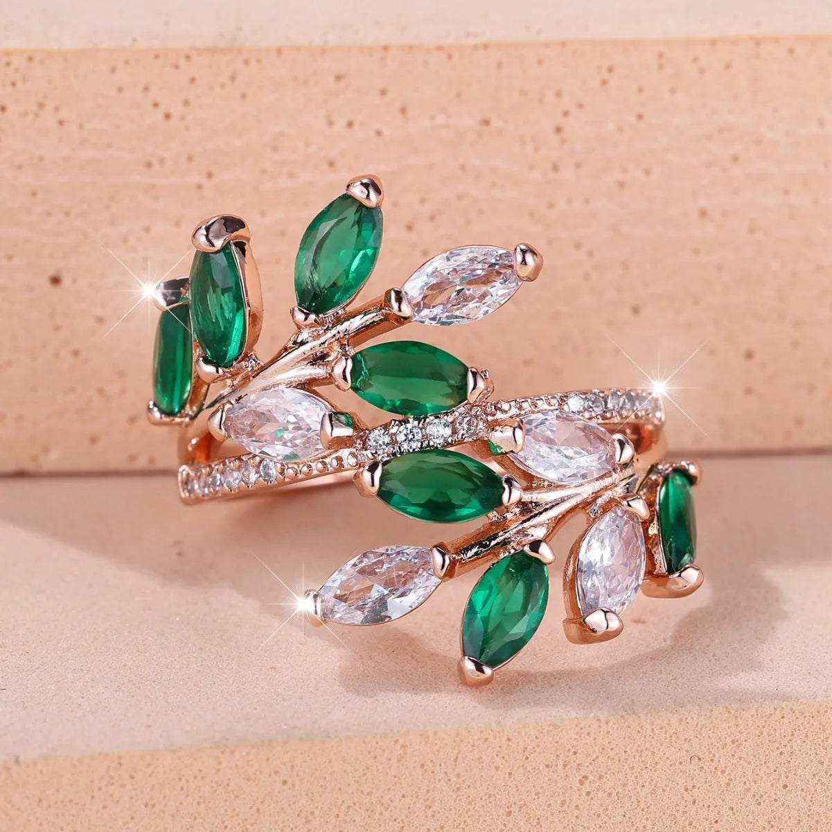 Adjustable open-ended leaf-shaped ring with zirconia stones on a copper band.