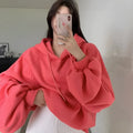 Women's loose watermelon red mulberry silk hooded pullover sweater on a hanger.
