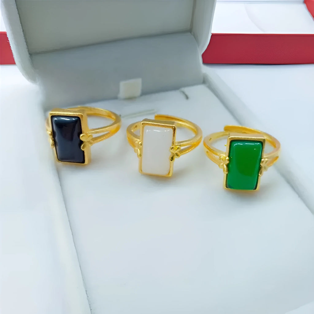 Gold-plated brass ring with a long green gemstone on an adjustable band.