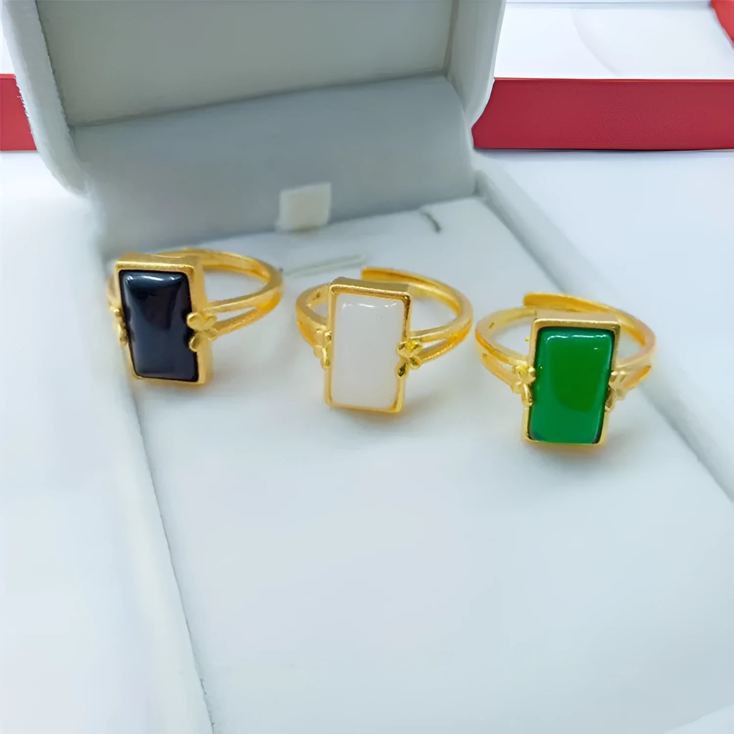 Gold-plated brass ring with a long green gemstone on an adjustable band.