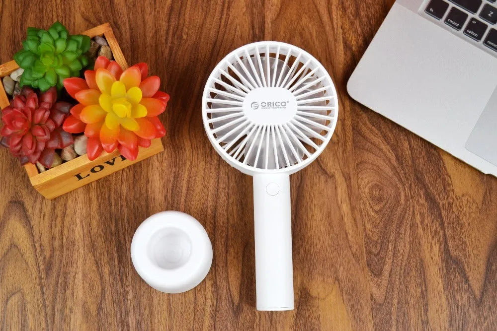 White ORICO FH1 portable USB rechargeable handheld desk fan with three-speed settings.