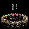 Natural citrine scattered beads ball bracelet showing polished stones on wrist.