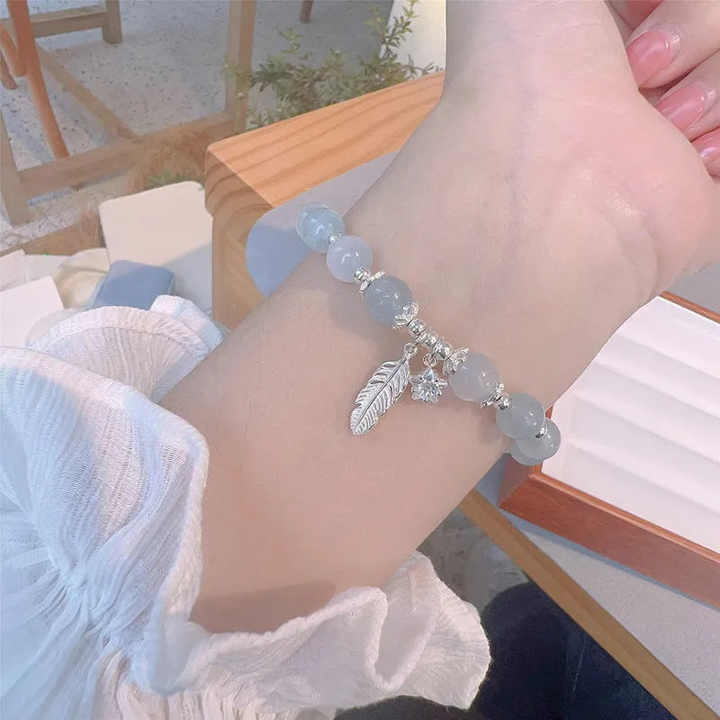 Glass crystal bracelet with coloured glaze in blue moonlight colour showing text modelling and eight-point star detail