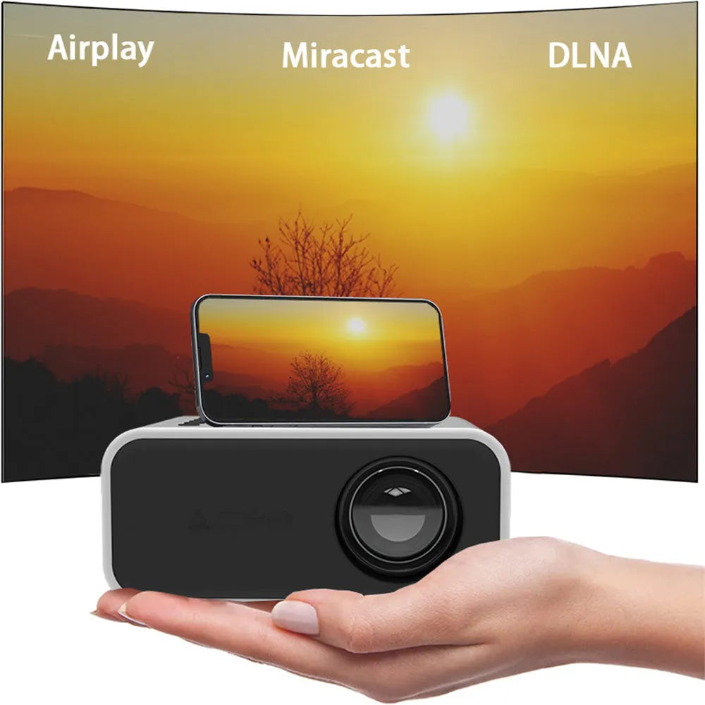 Black YT300 portable mini projector with remote control on a table.