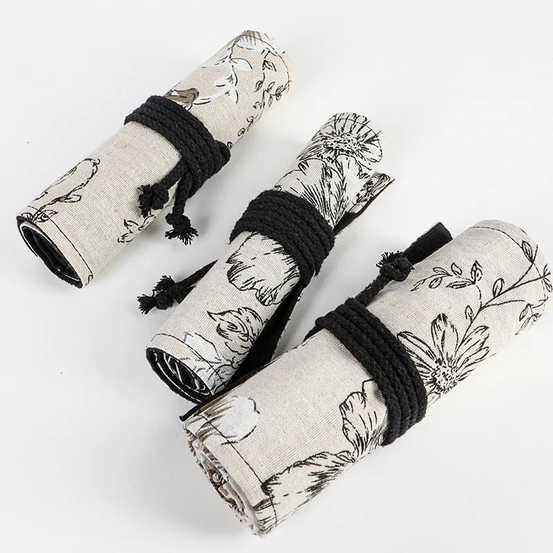 Square canvas pencil roll bag with black peony print design showing pencil pockets