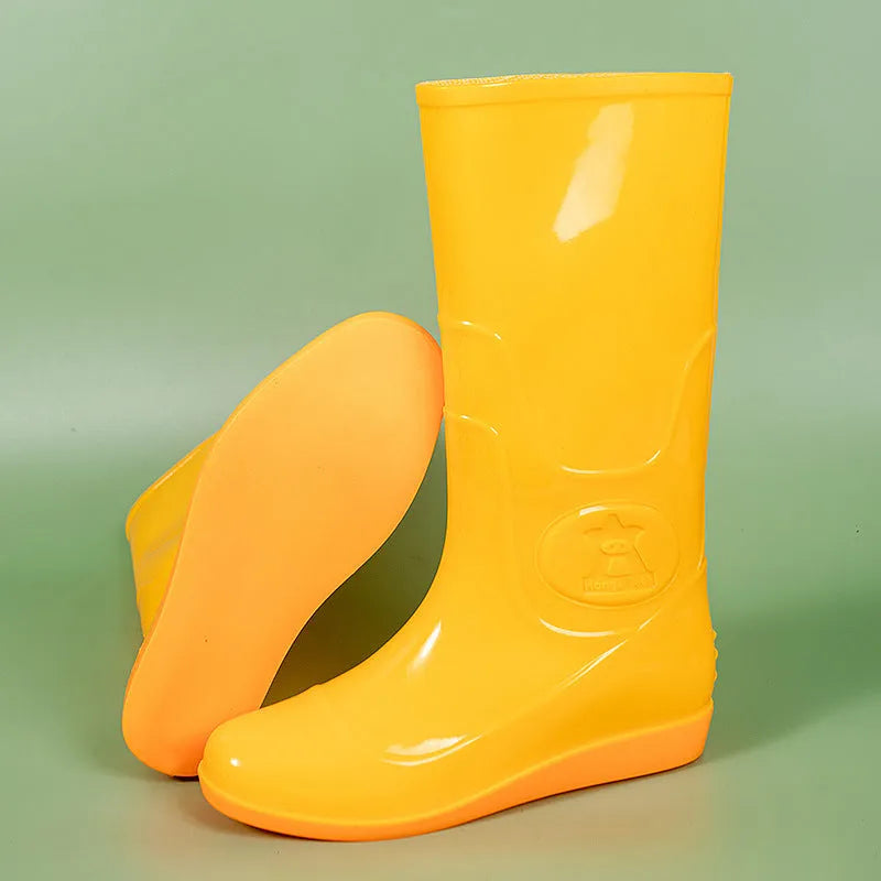 Flat washable plastic rain boots in white with high tube design and round toe
