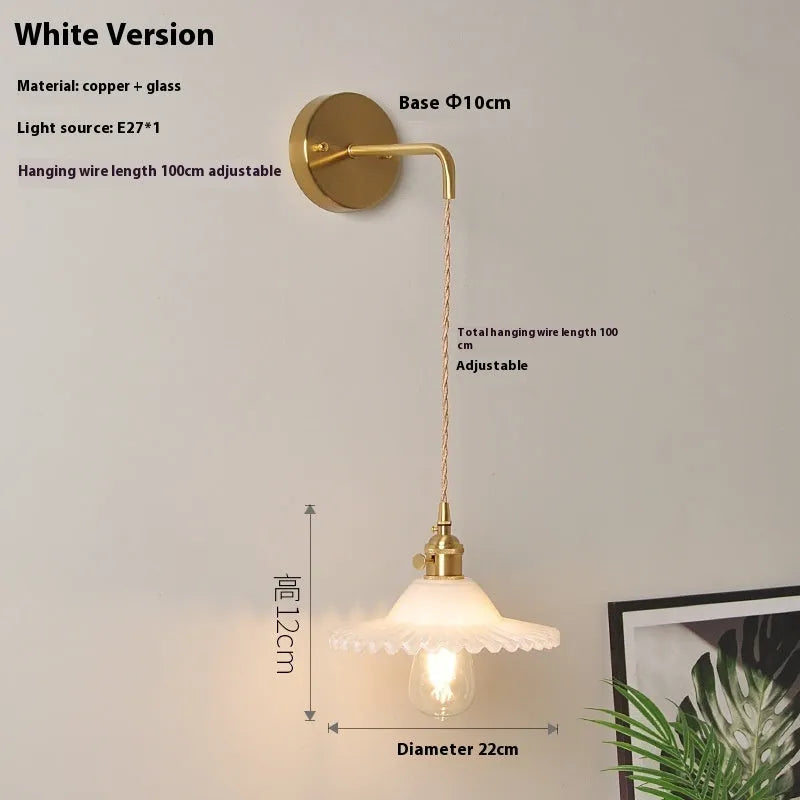 Retro brass lotus wall lamp with copper frame and glass shade on a wall
