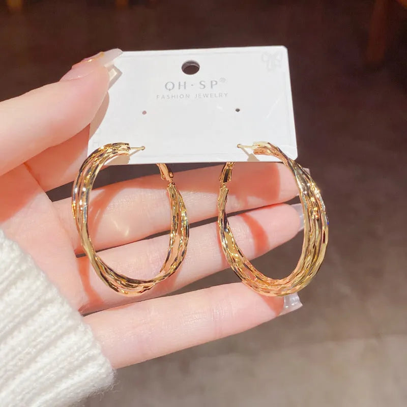 Silver Needle fashion simple metal twisted earrings in gold electroplated finish on copper base, round geometric shape