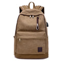 Canvas backpack with USB charging port showing laptop compartment and multiple pockets