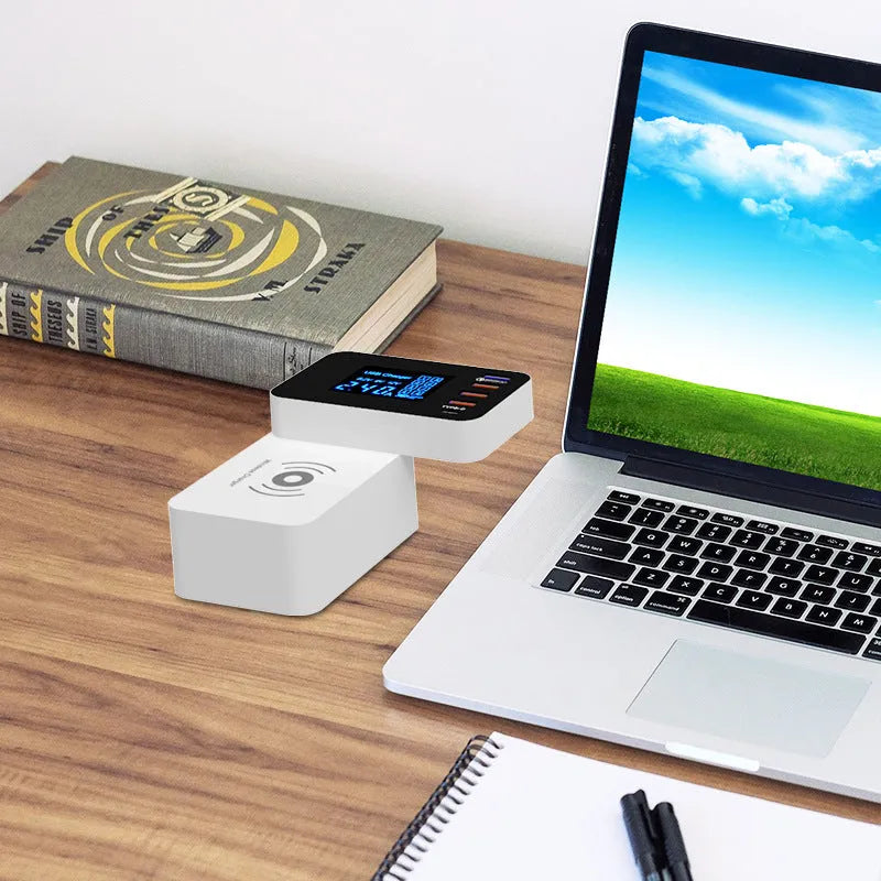 White multi-port USB fast charger with travel plug adapters and a long cable on a desk.