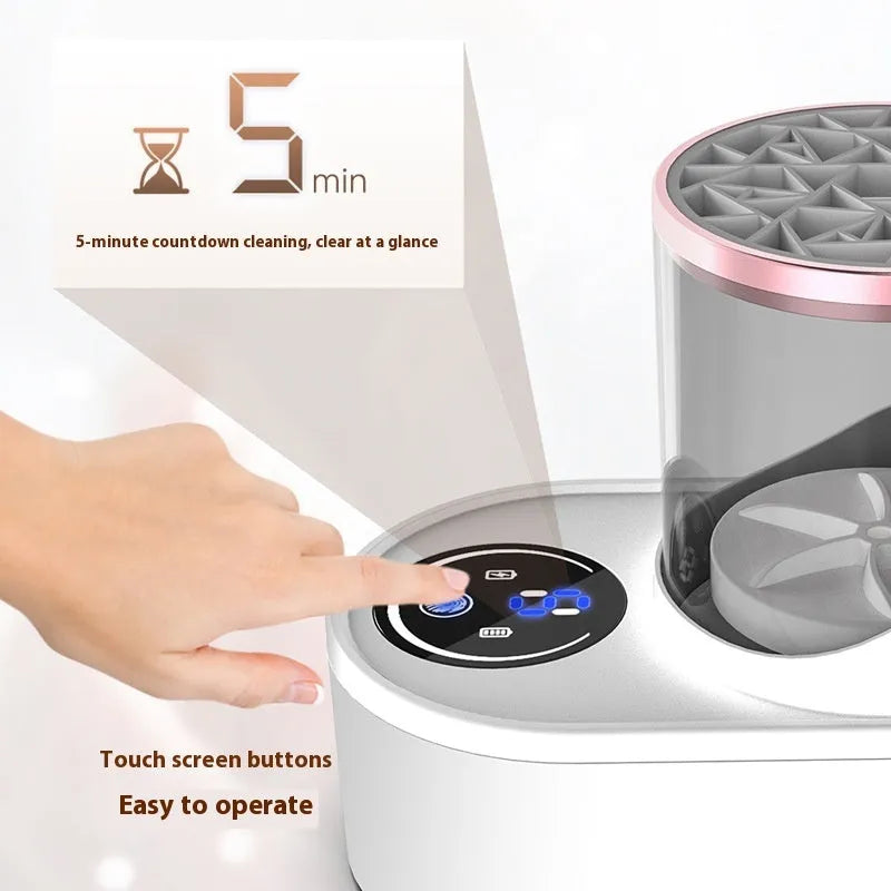 White electric makeup brush cleaner with drying chamber on a table, next to makeup brushes.