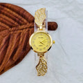 Stainless steel women's wristwatch with a round dial and vachette clasp, showing a gold-coloured surface.