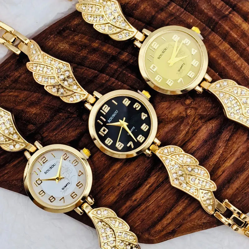 Stainless steel women's wristwatch with a round dial and vachette clasp, showing a gold-coloured surface.
