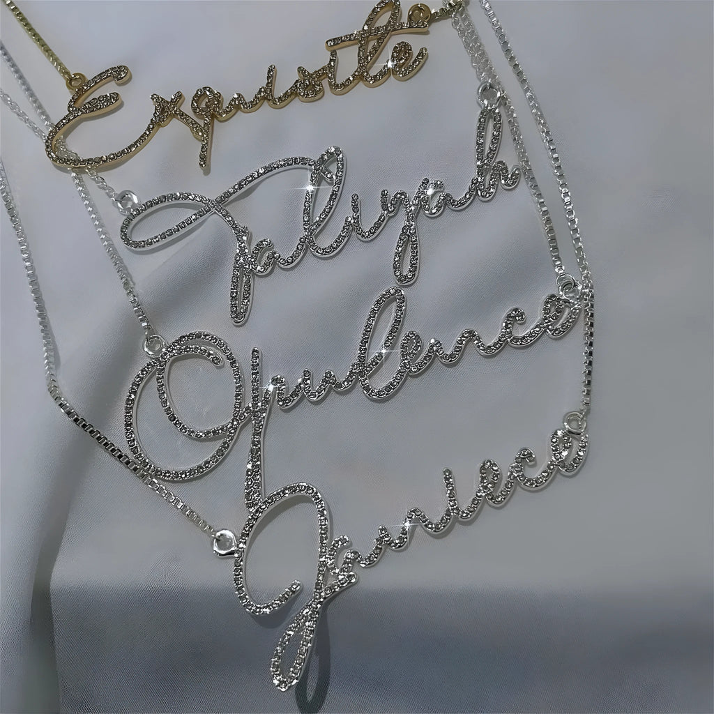 Personalised stainless steel name necklace with diamond-studded letters in silver, gold, or rose gold on a chain.