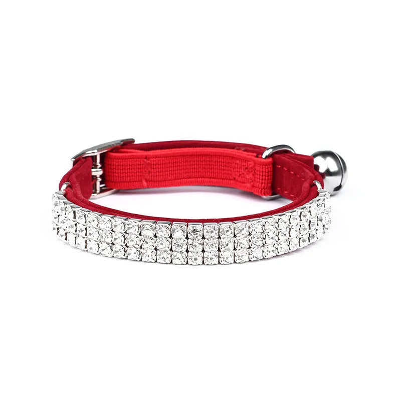 A red suede velvet cat collar decorated with rhinestones, showing the adjustable buckle.