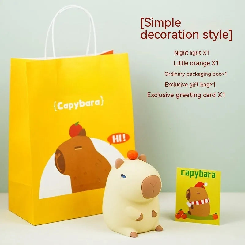 Small grey capybara-shaped silicone night lamp on a table.