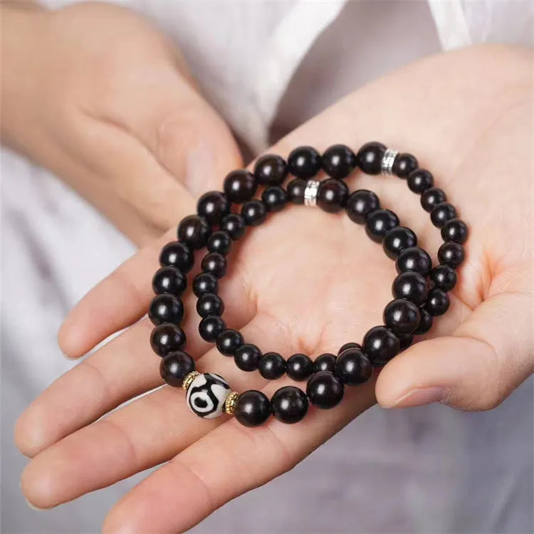 Ebony wood Tibetan prayer bead bracelet showing 8mm diameter and natural wood grain